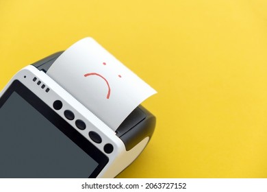 Online payment issue - cancel order, error. Closeup of POS terminal with touchscreen green display with printed reciept with a unhappy smile symbol on a yellow background. Problem shopping concept. - Shutterstock ID 2063727152