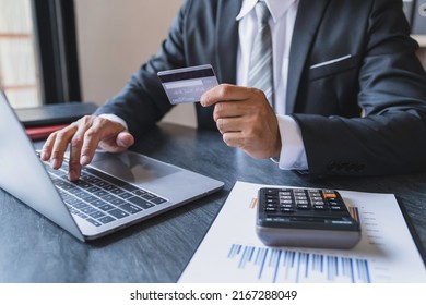 Online payment.Businessman hands holding a creditcard and using smart phone for shopping online.Close up
