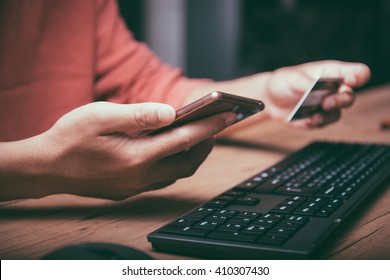 Online payment,hand using phone on worktable