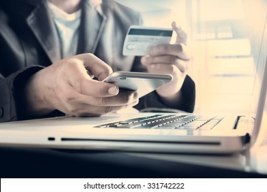 Online payment,Man's hands holding a credit card and using smart phone for online shopping
