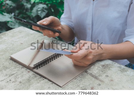 Online payment,Woman's hands holding a credit card and using smart phone for online shopping