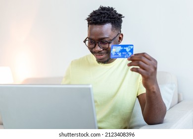 Online payment,Young Man holding credit card and computer laptop for online shopping. black friday or cyber monday concept. Man paying with credit card on laptop at home office