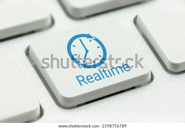 Online payroll payment services and online\
vendor payment, business concept : Clock logo with the word\
REALTIME printed on a computer keyboard button, depicting an\
instant money transfer to a\
receiver