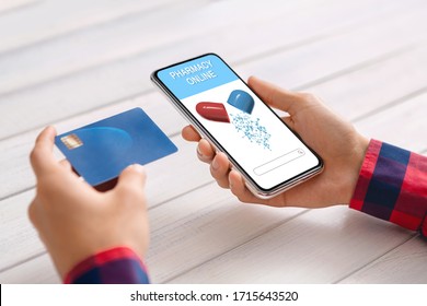 Online Pharmacy App. Male Hands Holding Credit Card And Smartphone With Opened Application For Ordering Drugs, Technologies In Healthcare Sphere