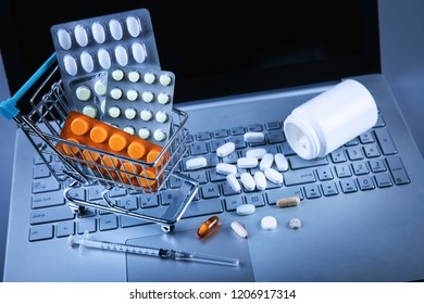 Online Pharmacy - Shopping Cart With Pills On Computer Keyboard