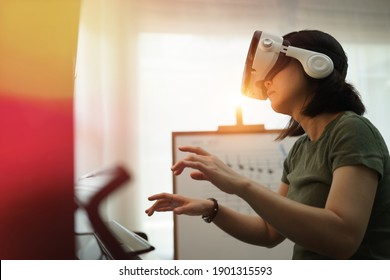 Online Piano Music Lesson By Virtual Reality At Home, VR Musical Online Learning Conceptual. Young Student Learning Piano From Virtual Network, Pianist Conduct Student From Metaverses Technology.