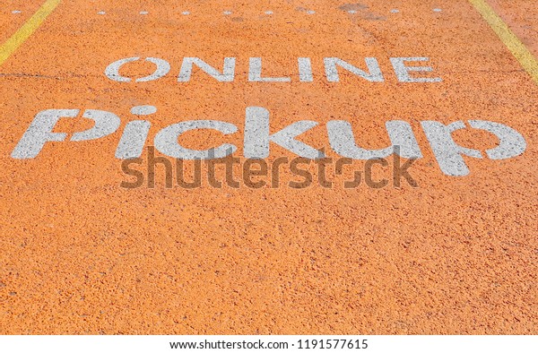 Online pickup sign\
painted in parking space