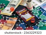 Online poker concept. Smartphone and poker chips on a green background. Poker online banner. Copy space. Vignette. Place for text. Gambling. Background.