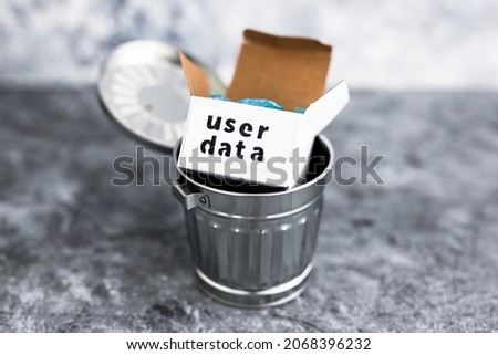 online privacy and stored information concept, metaphor of box with User data label thrown into recycle bin