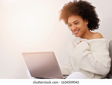 Online psychotherapy .Cozy beautiful woman wearing knitted knitted off-shoulder sweater . Lifestyle concept