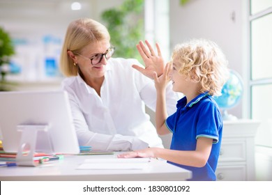 Online Remote Learning. School Kids With Computer Having Video Conference Chat With Teacher And Class Group. Mother Helping Son. Child Studying From Home. Homeschooling In Coronavirus Outbreak.