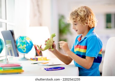 Online Remote Learning. School Kids With Computer Having Video Conference Chat With Teacher And Class Group. Child Coloring Clay Dinosaur. Arts And Crafts For Kid From Home From Home. Homeschooling.