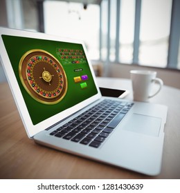 Online Roulette Game  Against Laptop By Coffee Cup On Table