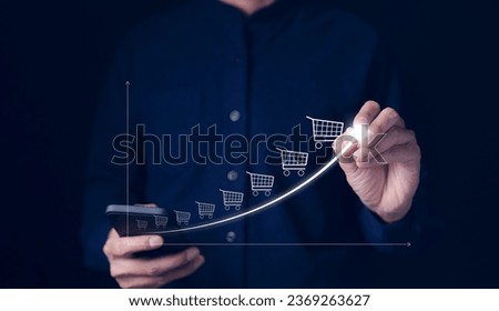 Online sale business growth concept. Businessman drawing increasing trend graph of sale volume with bigger shopping trolley cart. long term investment growth goal, Digital Marketing Strategies,