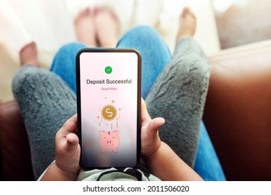 Online Saving Money For Kids Concept. Parent And Smart Child Using Mobile Phone To Making Money Deposite Via The Internet. E-Banking Smartphone Application  