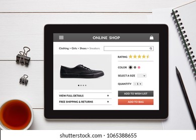 Online Shop Concept On Tablet Screen With Office Objects On White Wooden Table.