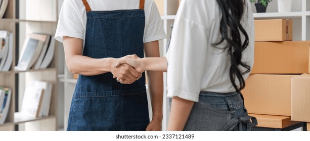 Online shopping Asia couple handshake to express joy and success. Online shopping concept - Powered by Shutterstock