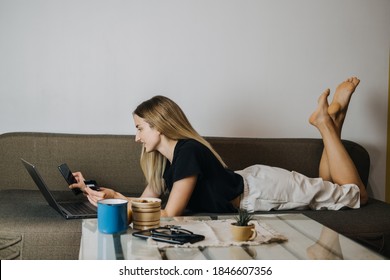 Online shopping, Black Friday sale, Holiday deals e-commerce, internet banking, spending money concept. Young woman at home holding credit card and using laptop computer and phone. Selective focus - Shutterstock ID 1846607356