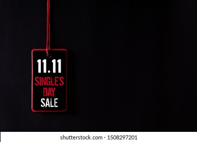 Online shopping of China, 11.11 single's day sale concept. Top view of Black and red paper tag with the text 11.11 single's day sale on a black background.