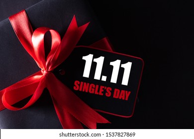Online shopping of China, 11.11 single's day sale concept. black and red paper tag with ribbon on black background with copy space for text 11.11 single's day sale.