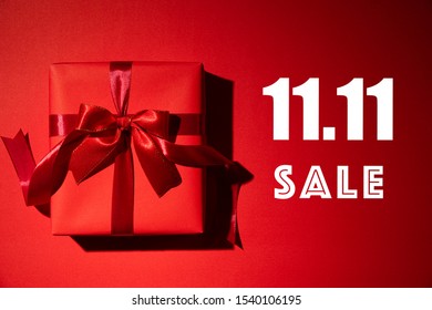 Online Shopping Of China, 11.11 Singles Day Sale Concept. Top View Of Christmas Boxes With Red Ribbon On Red Background With Copy Space For Text  11.11 Singles Day Sale.