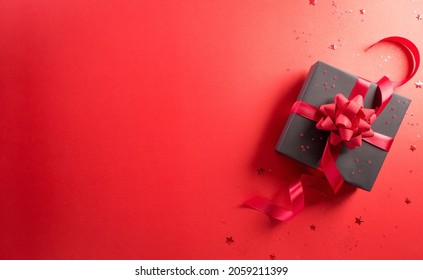 Online Shopping Of China, 11.11 Singles Day Sale Concept. Top View Of Black Christmas Gift Boxes With Star On Red Background With Copy Space.