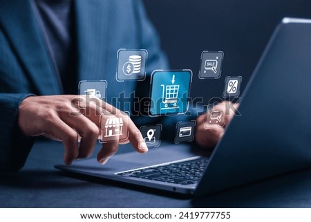 Online Shopping concept. Businessman use laptop with virtual screen of online shopping icon. Explore a seamless online shopping service with convenient home delivery options.