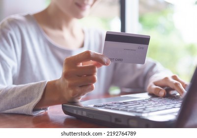 Online Shopping Concept  E-Commerce  Internet Payments Financial Security. Woman Holding A Credit Card And Typing Information On A Keyboard Laptop.