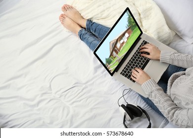 Online shopping concept. Woman looking for house on real estate market website