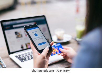 Online Shopping Concept, Young Asian Woman With Payment Success On Mobile Phone Screen Using Credit Card To Buy Product On Online Retail Shop With Laptop Computer At Coffee Cafe, Lifestyles Technology