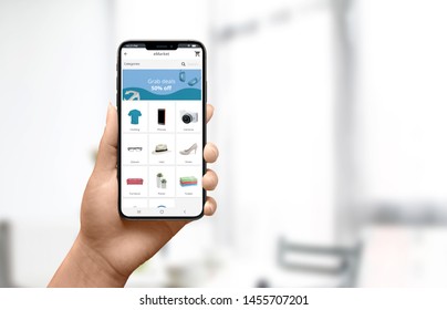 Online Shopping At Home Concept. Woman Holding Phone And Use Modern Online Store Website For Fin Products.