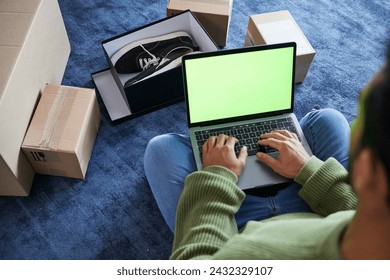 Online shopping, man with laptop, green screen and package on floor, shoes and delivery service on digital app. Sale, discount and ecommerce on fashion retail website, internet search on computer. - Powered by Shutterstock