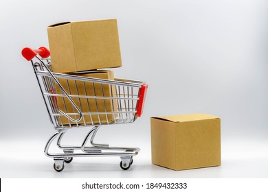 Online shopping and shipping concept, Shopping cart and post boxes on white background, Mini red blank trolley with free copy space, Business and financial background. - Powered by Shutterstock