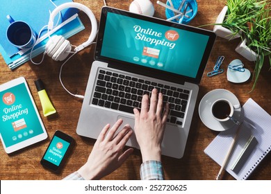 Online shopping website on laptop screen with female hands typing - Shutterstock ID 252720625