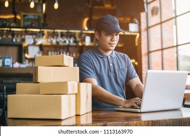 Online shopping young start small business in a cardboard box at work. The seller prepares the delivery box for the customer, online sales, or ecommerce.