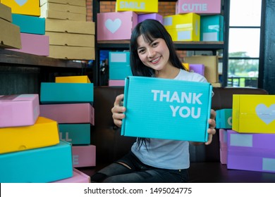 Online Shopping Young Start Small Business In A Cardboard Box At Work.The Seller Prepares The Delivery Box For The Customer,online Sales, Or Ecommerce.,Sales Concept.