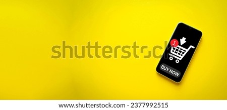Online shopping,Delivery, e-commerce,world shipping,omnichannel concept.,Smartphone on yellow background with shopping cart icon on screen with copyspace idea for tecgnology,business,lifestyle.