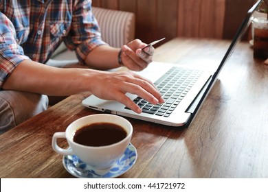 Online shopping.Hands holding credit card and using laptop. hand typing keyboard and use credit card  shopping online,personal loans,businessman hand busy using laptop at office desk,