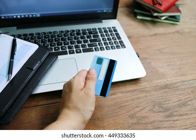 Online shopping,hands holding credit card and using laptop,personal loans, working in coffee shop, businessman hand busy using laptop at office desk,shopping online lifestyle