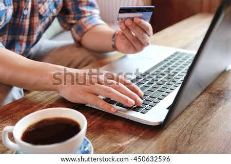 Online shopping,hands holding credit card and using laptop,personal loans, working on  in coffee shop, businessman hand busy using laptop at office desk,shopping online lifestyle,