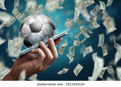 Online Sports Betting. Dollars Are Falling On The Background Of A Hand With A Smartphone And A Soccer Ball. Creative Background, Gambling