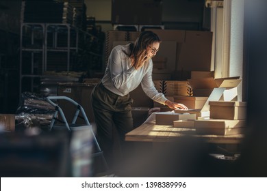 Online store businesswoman working on laptop and taking on the phone. Female business professional taking order on phone.