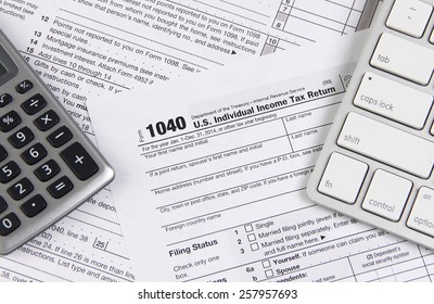 Online Tax Filing - Federal 1040 Form With Computer Keyboard And Calculator