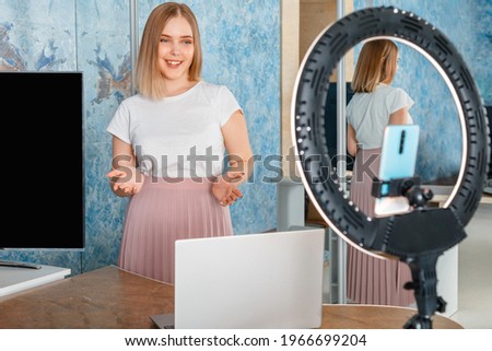Online teacher records video lessons. Manager do presentation during online meeting. Woman record stream using laptop smartphone ring lamp. Coach mentor blogger influencer do live stream webinar