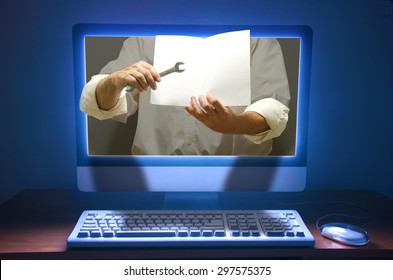 Online Technical Support, Training, Teaching And Learning Concept Showing Hand Holding A Wrench And Blank Instructional Booklet Coming Out Of A Computer With Dramatic Lighting. 