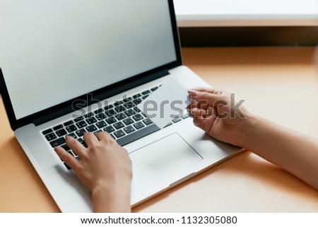 Online Technology Payment Laptop Working. Close-up of woman holding credit card and using laptop