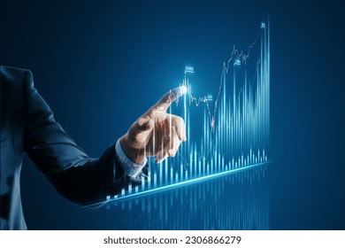 Online trading and investing concept with a businessman finger pressing a button on a virtual forex chart on a digital display hologram, on a dark blue background