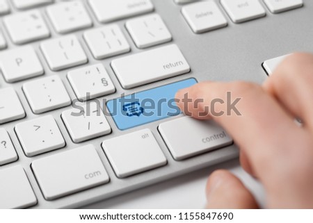 Online translator and language e-learning course concept. Computer user press keypad on keyboard with symbol of translation (speech bubble with arrows and abstract text).