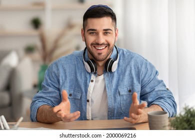 Online Video Call. Portrait Of Smiling Jewish Man In Kipa Having Virtual Conference With Colleagues Or Students Using Computer, Talkng And Gestirung, Sitting At Desk At Home Office, Webcamera View