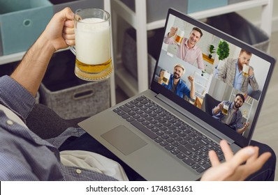 Online Video Chat Friends Party. A Man With A Glass Of Beer Greets Friends Having A Laptop Video Conference At Home.